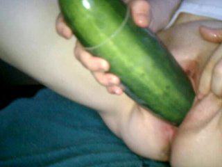 Cucumber spreading pink pussy.